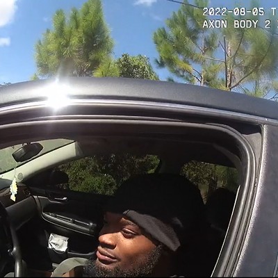 In a screenshot from a sheriff's body camera video, Darius Jermaine Ned Thomas Jr., 22, of Jacksonville, Florida, leans out his driver's window Aug. 5, 2022, to accept a $114 ticket from Jacksonville Sheriff's Office deputy M.L. Albert for playing his music too loudly. Black drivers, like Thomas, are nearly three times as likely as white ones to be ticketed under the law, according to a new investigation by the University of Florida College of Journalism and Communications.
