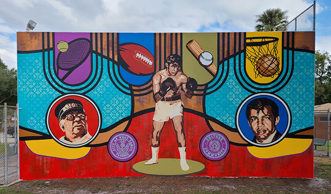 Cumbas returned to the park in 2022 to restore “Kaleidoscope” and further tell West Tampa’s story through its love of sports. In a second mural, “Measured,” Cumbas and Jay Giroux depict West Tampa boxing legends Fernando “Ferdie” Pacheco, M.D., and Joe “King” Roman on the western facade of the MacFarlane Park racquetball courts.
Photo via City Of Tampa