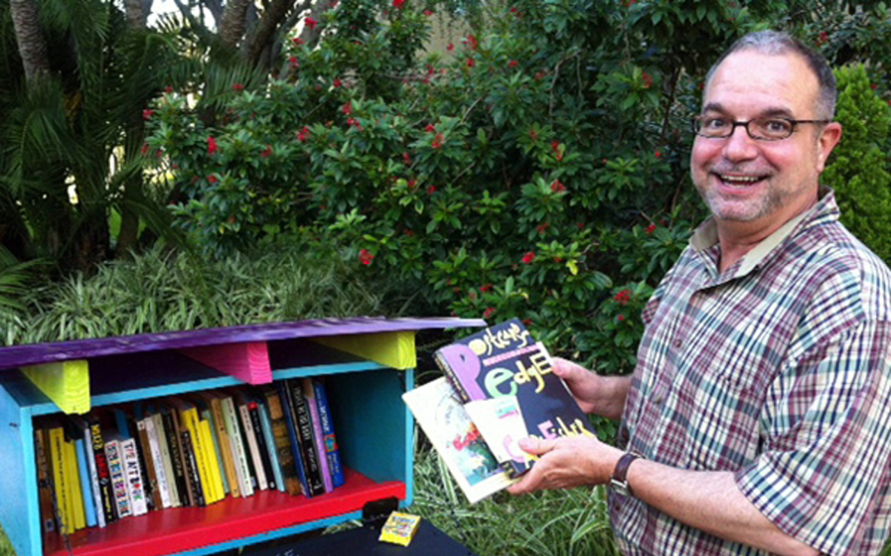 HERE, READ THIS: Jose Gelats donates to a book box in downtown St. Pete.