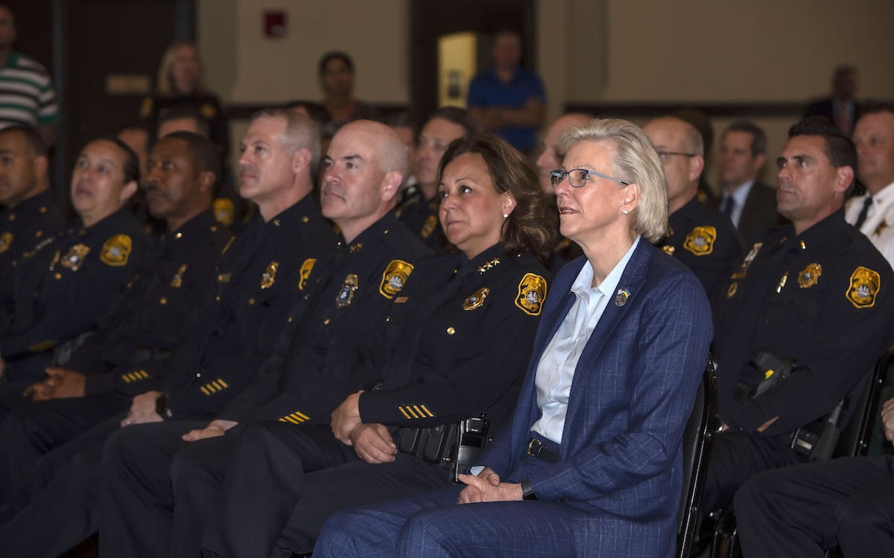 Tampa Police Chief Mary O'Connor sits next to Mayor Jane Castor (right) during Butch Delgado's retirement ceremony at the University of Tampa.
