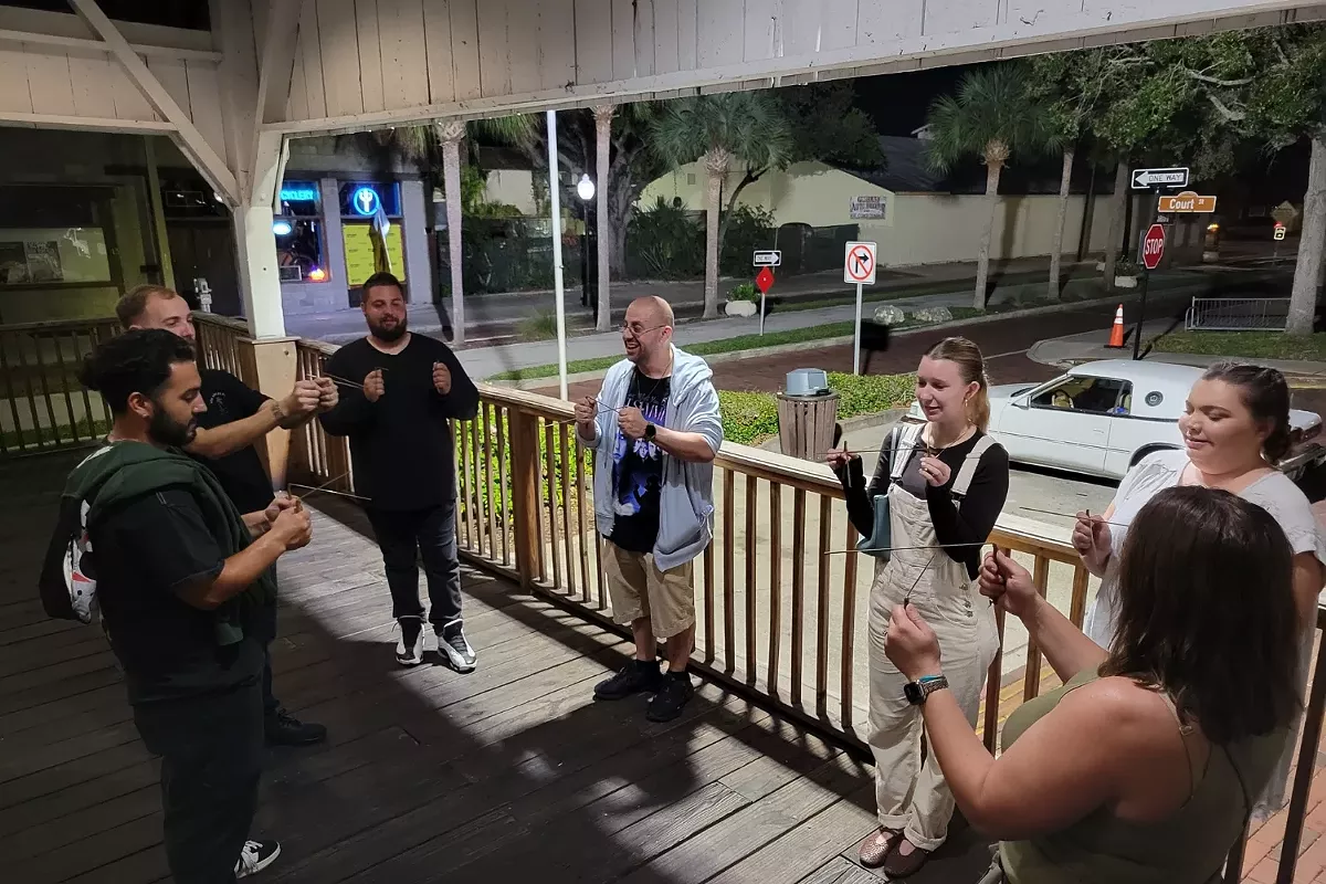 Silent Slayer Ghost Tours leading an after-dark walking tour in historic downtown Tarpon Springs, Florida.