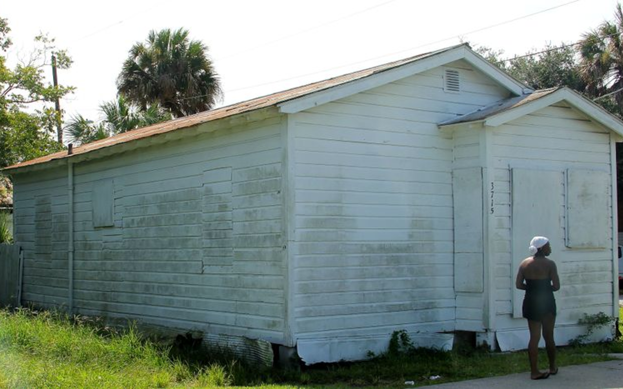 One of the many boarded-up East Tampa houses passed on the 99 Percent Tour.