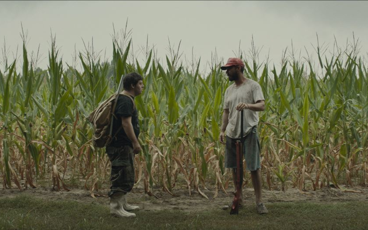 Zak (Zack Gottsagen, left) and Tyler (Shia LaBeouf) discuss the ground rules of their journey to Florida in The Peanut Butter Falcon.