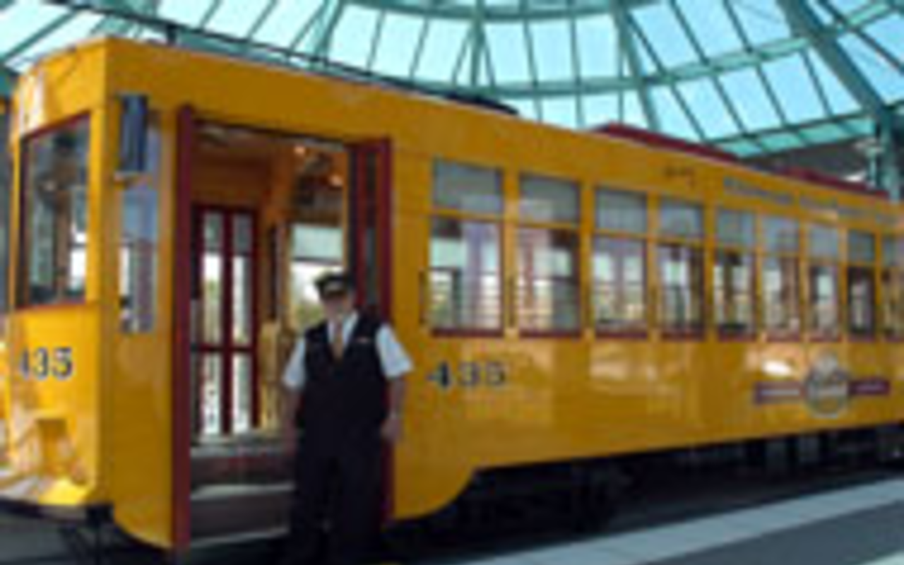 Let's, uh, roll:Conductor Robert Garcia stands in front 
    of the trolley.