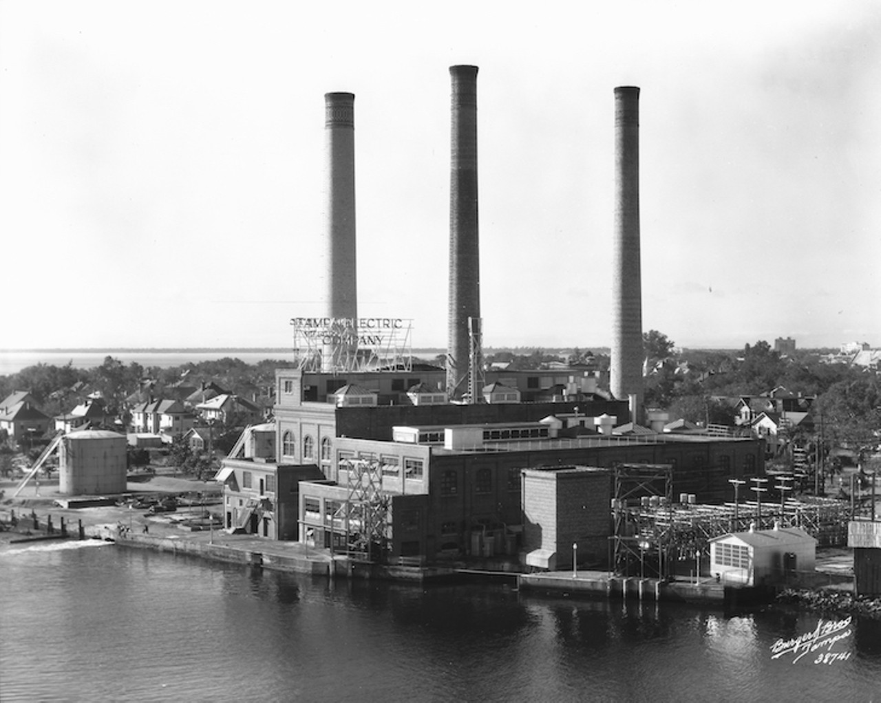 THEN
Tampa Electric Company power plant on Hillsborough River
Looking southwest, 1936
This Tampa Electric coal-fired plant operated on the banks of the Hillsborough River, using its water for cooling. Before becoming the city&#146;s primary electricity supplier, Tampa Electric was in the business of operating streetcars in the 1920s. As they grew to be the primary electrical utility for Tampa, public outcry about exorbitant prices for power and charges of political corruption were leveled in the 1930s and 1940s. The Tampa Tribune moved to the property on the west side of Hillsborough River after the construction of its new building in 1974. In March of 2000, the new $40 million WFLA Channel 8 building opened adjacent to the Tribune building as the two entities- both owned by Media General- joined forces to create the first-of-its-kind news service.