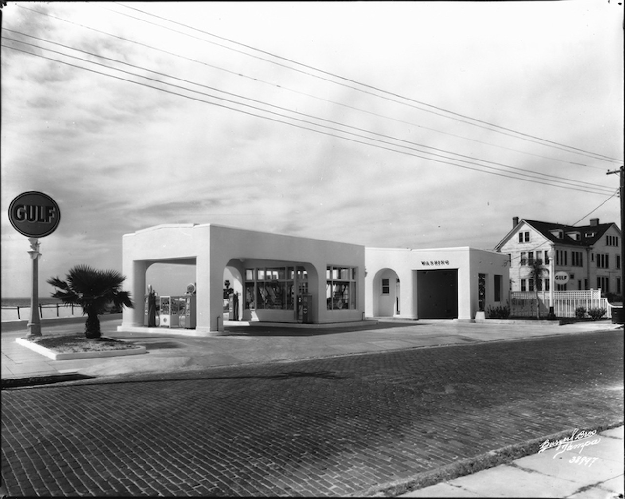 THEN
Gulf service station
Bayshore Boulevard and Swann Avenue, 1936
Gulf Oil Corporation of Pennsylvania service station was at the intersection of Bayshore Boulevard and Swann Avenue. In the 1950&#146;s it was named Latimer&#146;s Gulf Service. It was a popular outlet being central to Hyde Park and Davis Islands. If one looks closely, a wooden fence and sand line Bayshore Boulevard where the Beaux-arts style balustrade-built in the late 1930s- now stands.