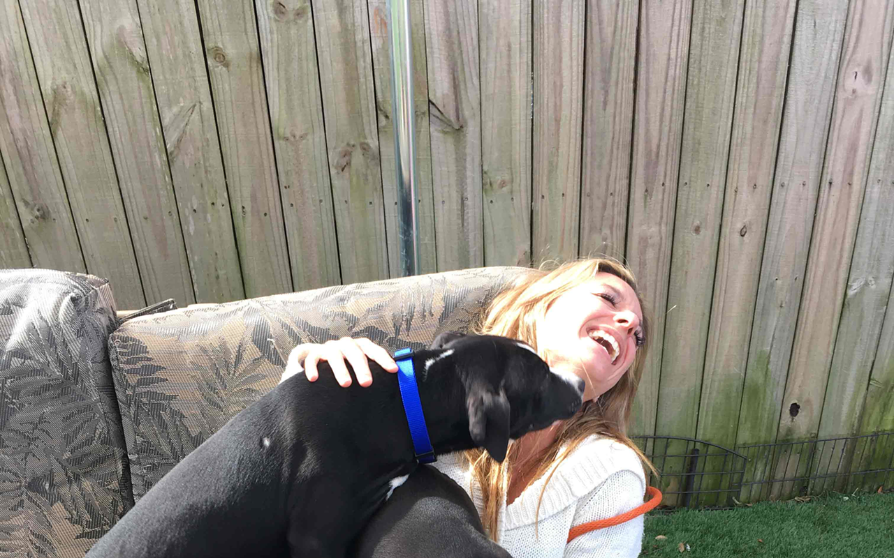 Suncoast Animal League volunteer dog walker Katie Mleczko accepts her payment.