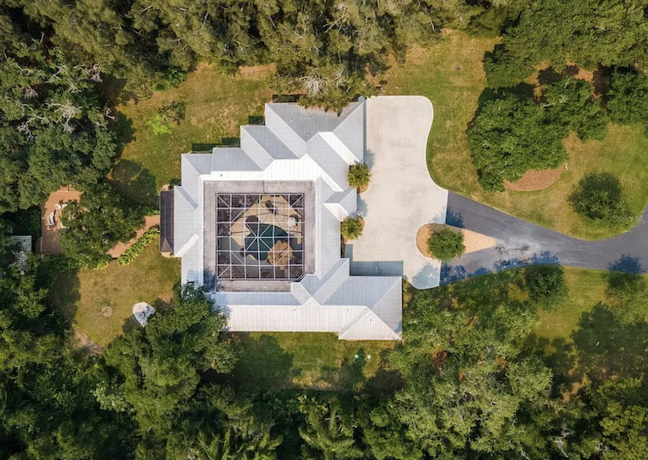 This Sarasota house is built around a grotto, and comes with a tree house and a 'fish camp'