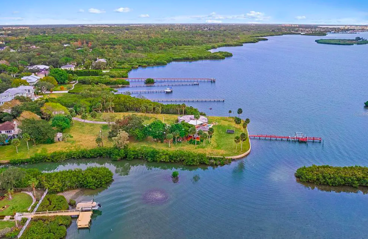 This Tampa Bay home sits on its own 2-acre peninsula and comes with an indoor koi pond and a bird-cage elevator