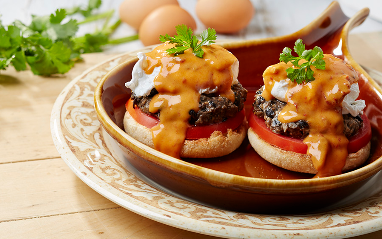 Served on an English muffin, Another Broken Egg's black bean Benedict features grilled black bean cakes, tomato, poached eggs, chipotle hollandaise and cilantro.