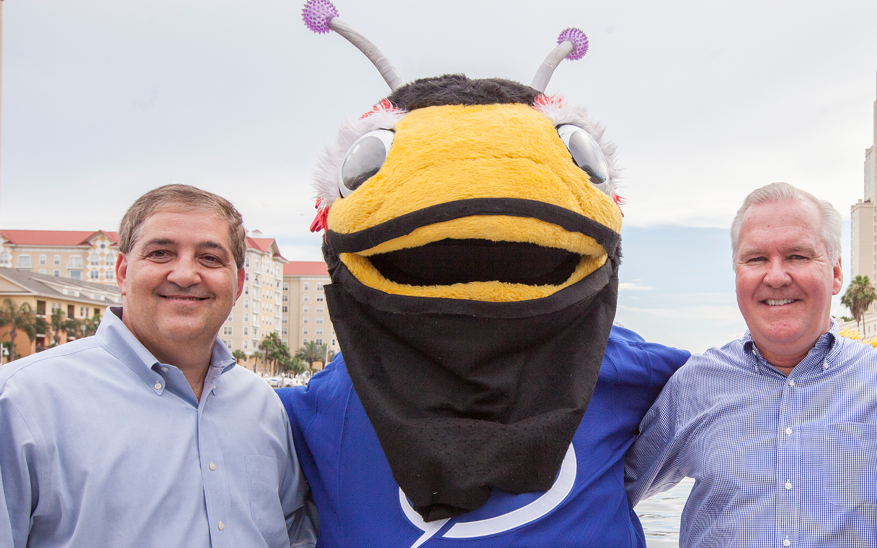 Vinik, left, and Tampa Mayor Bob Buckhorn pose with the Tampa Bay Lightning bug.