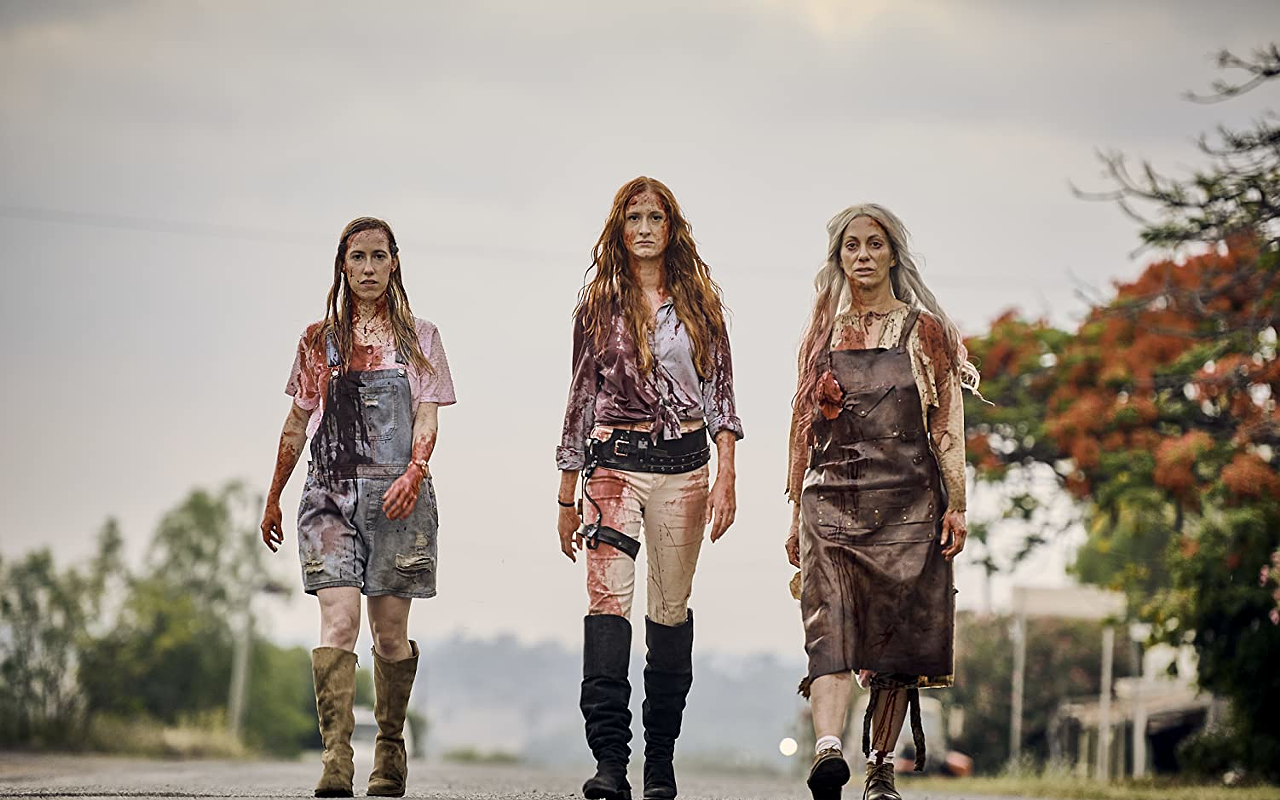 Annabelle, center, flanked by her sister Daisy, left, and mother Mary, right, model their best blood couture from "Two Heads Creek."