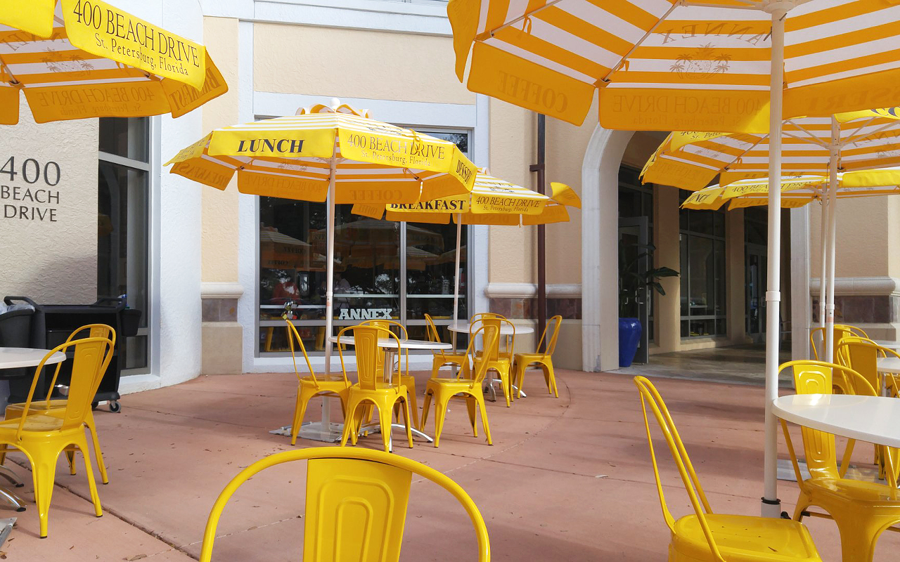 Yellow umbrella-shaded patio furniture beckons passersby to the newly opened Annex 400 Beach.