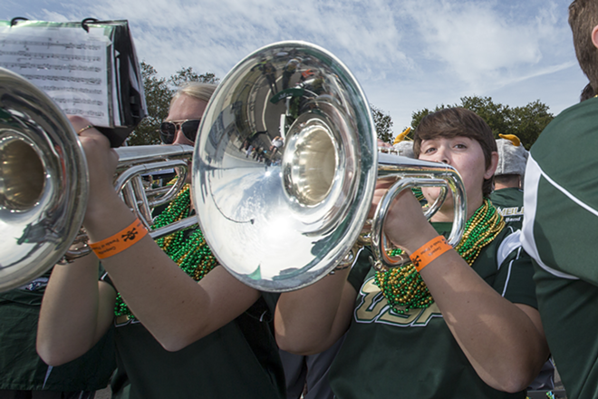 Stacey Jones of the USF band plays on the university's float. - Chip Weiner