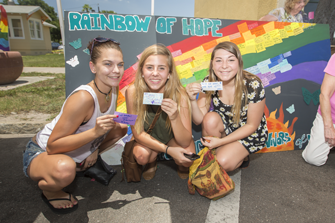 Amber Fowler, Amanda Warra, and Raven Kilpatrick add their positive thoughts to the Crisis Center of Tampa Bay's Rainbow of Hope board for suvivors of violence. - Chip Weiner