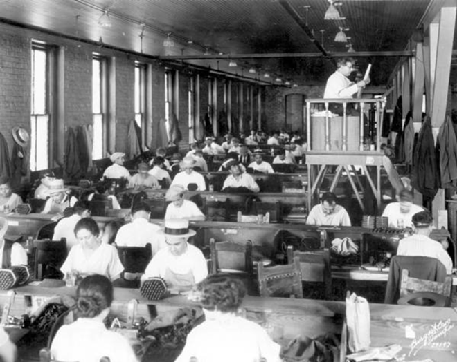 A lectore reads from the traditional elevated platform at the Cuesta-Ray cigar company in Ybor, 1929. - State Archives of Florida