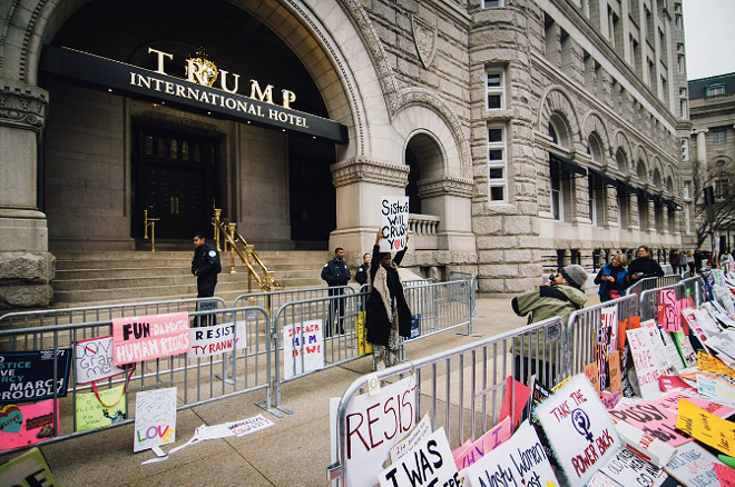 The signs pile up outside Trump's hotel. - Anthony Martino