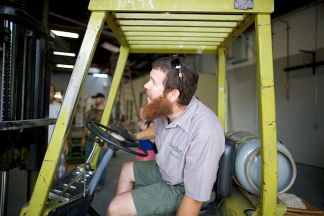 Green Bench founder Steven Duffy mans the forklift during the brewhouse installation. - Todd Bates