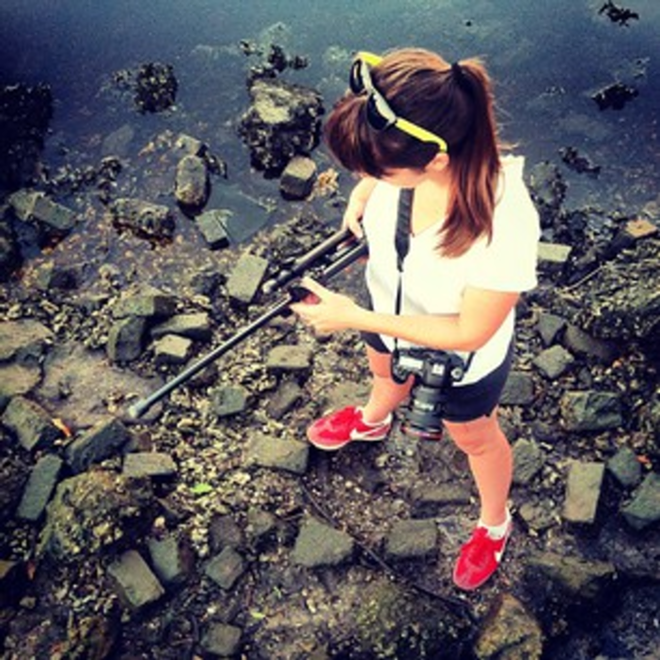 Abbett treads the banks of the Hillsborough, setting up for her time lapse photo shoot. - Jared Fager