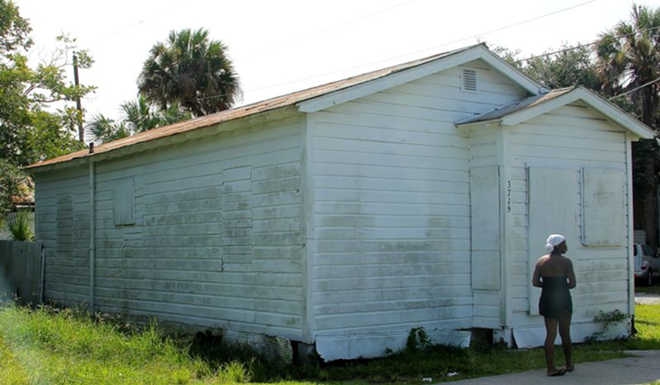 One of the many boarded-up East Tampa houses passed on the 99 Percent Tour. - Daniel Veintimilla