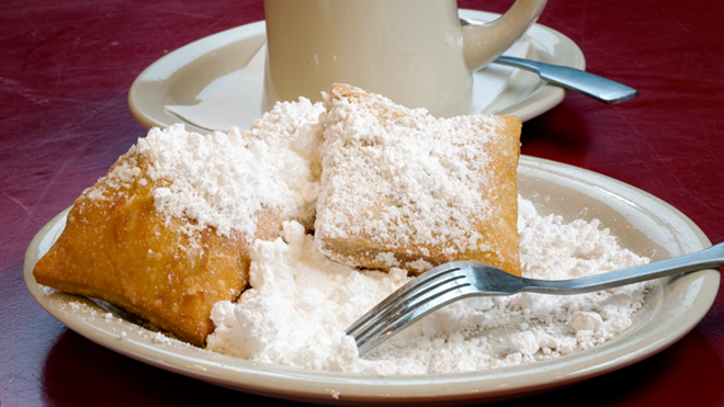 Buried in powdered sugar, beignets are one of the menu's two dessert options. - Chip Weiner