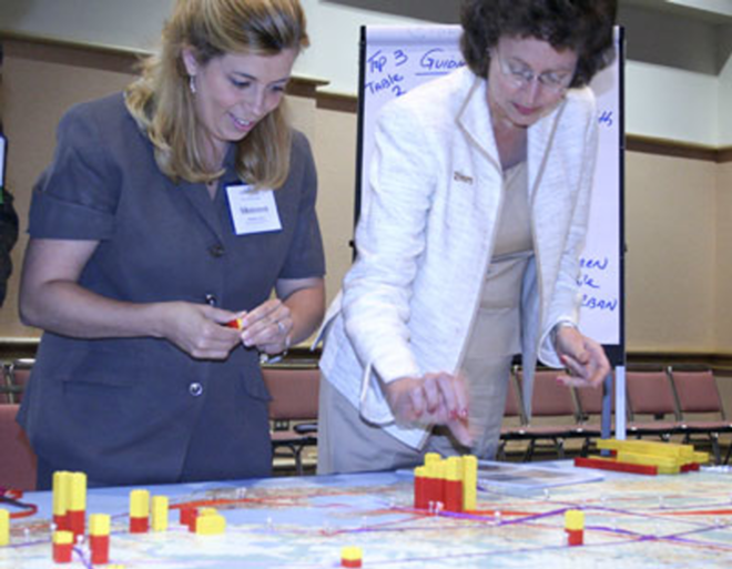 LEGO OUR FUTURE: Mayor Pam Iorio (right) and Shannon Patten of Publix Supermarkets use blocks and ribbons to map out Tampa Bay development. - Wayne Garcia