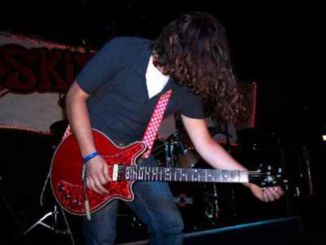 ROCK 'N' ROLL RUMORE: Hat Trick Heroes guitarist Santino Rumore wows the crowd with a fierce solo. - Wade Tatangel0