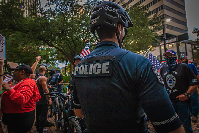 Police stand between protesters and Back the Blue stans in downtown Tampa, Florida on August 12, 2020. - DAVE DECKER