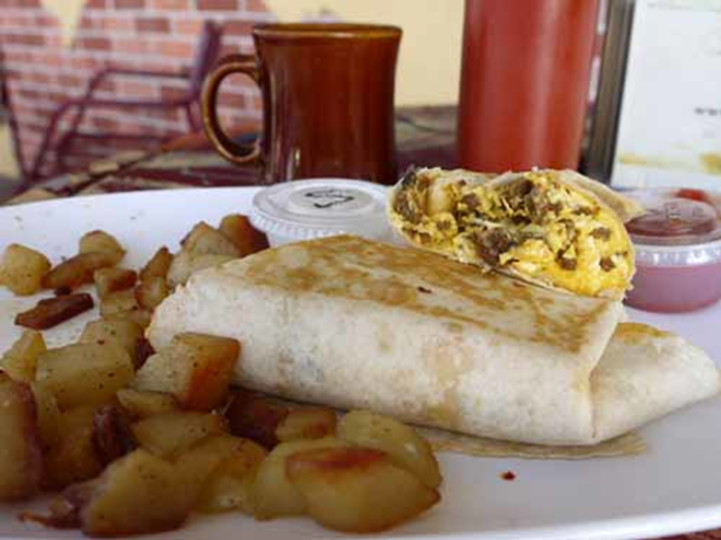 Foxy's breakfast burrito special is tasty, but better when slathered with the restaurant's classic wing sauce. - BRIAN RIES