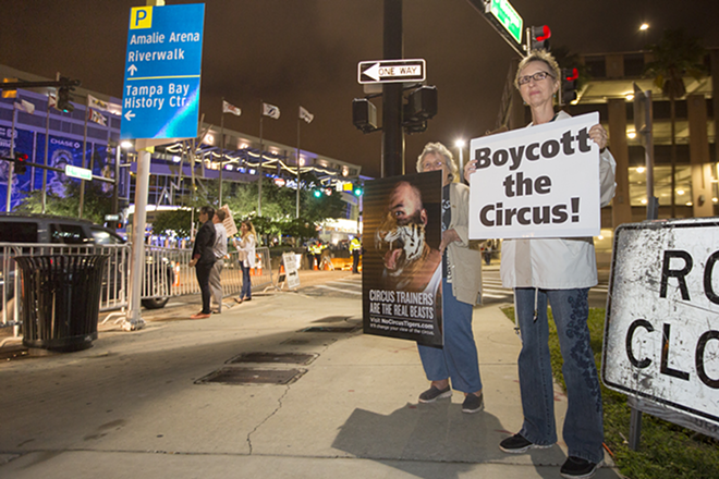 Organizers Diane Koon and Marie Galbraith stand on the sidewalk on Morgan Street attempting to educate circus-goers about animal abuse and exploitation. - Chip Weiner