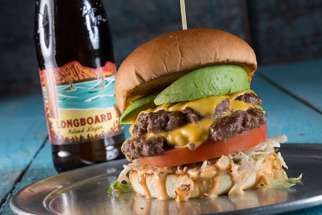 The Santa Barbara, a signature Jimmy Hula's double cheeseburger with grilled onion, avocado, lettuce, tomato and "voodoo" sauce. - Jimmy Hula's