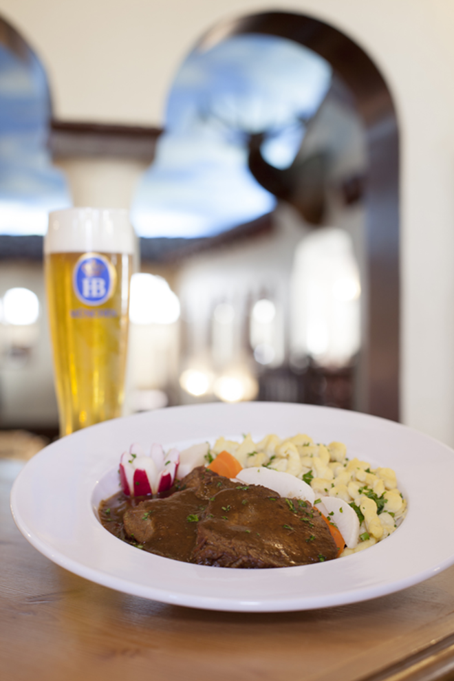 Hofbräuhaus's Bavarian pork and beef specialty, Oktoberfest Bratenteller, with veggies, spaetzle and more. - Nicole Abbett