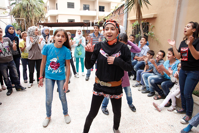 YEARNING TO BREATHE FREE: Syrian refugee children celebrate upon reaching Lebanon. - creative commons