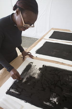 Norwood working on her "Luminous Shaddow" charcoal drawings from her 2015 Luminous Bodies Residency in Canada - Teresa Ascencao
