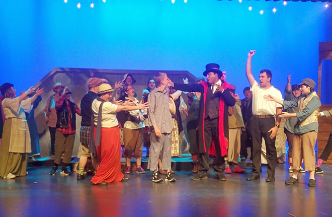 The Artful Dodger (Jordan Krolak) and company serenade young Oliver Twist (A.J. Rommel) in the Theatre eXceptional production of Oliver!. - Bill DeYoung