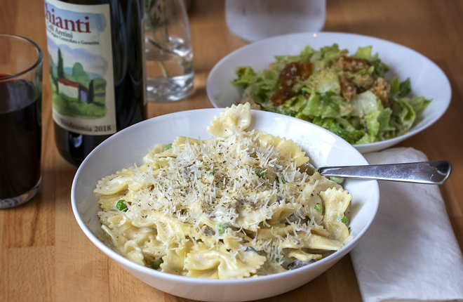 The carbonara pasta is built upon farfalle bow-ties tossed with bright green peas and sliced mushrooms in a creamy cashew sauce with vegan parm. - CHIP WEINER