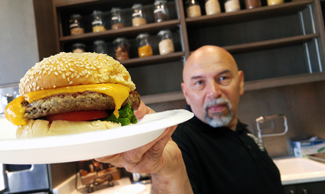 Chef Luis Flores of Ciccio Restaurant Group with the Impossible Burger, dressed in classic fixin's. - Meaghan Habuda