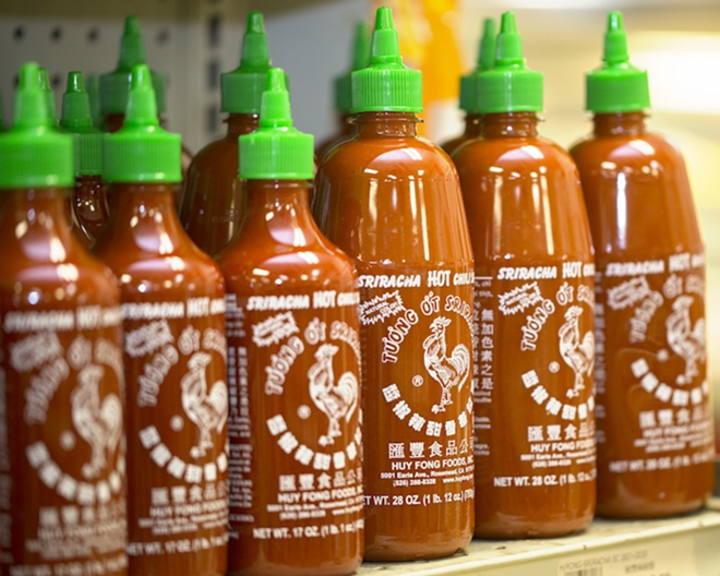 POPPYCOCK: At Tampa’s Oceanic Asian Supermarket, locals stocked up on Huy Fong Foods’ Sriracha rooster sauce last week. - Chip Weiner