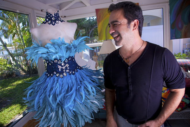 FEATHERED FRIEND: Martins in his home studio with a Wearable Art 8 creation inspired by Amazonian birds. - Shanna Gillette
