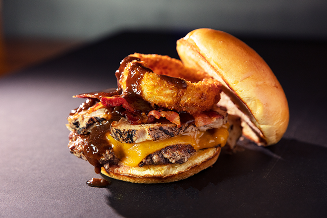 The Ultimate Chophouse Burger with pulled pork, smoked bacon, Cheddar, an onion ring and A.1. - Courtesy of Burger Monger