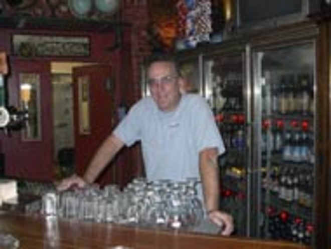 PROUD PAPA: New World owner Steve Bird tends bar. - Scott Harrell