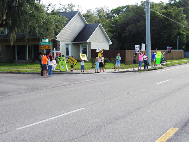 BIG-BOX BLUES: Protestors rally against a proposed big-box development on May 7 on Bloomingdale Avenue and Lithia Pinecrest Road. - George Niemann