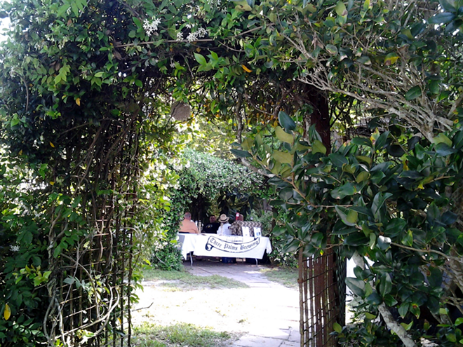 Pearl in the Grove's archway of tangled greenery that welcomed about 115 diners to Swinefest No. 2. - MEAGHAN HABUDA