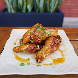 The newbie's calamansi caramel chicken wings. - Courtesy of Armature Works