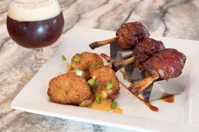 Bacon-wrapped chicken lollipops, pictured with a St. Petersburg-made imperial red. - Nicole Abbett