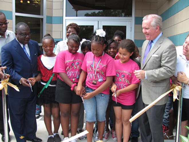 Mayor Bob Buckhorn and Sulphur Springs students join in cutting the ribbon to open the new Springhill Community Center. - Kate Feldman