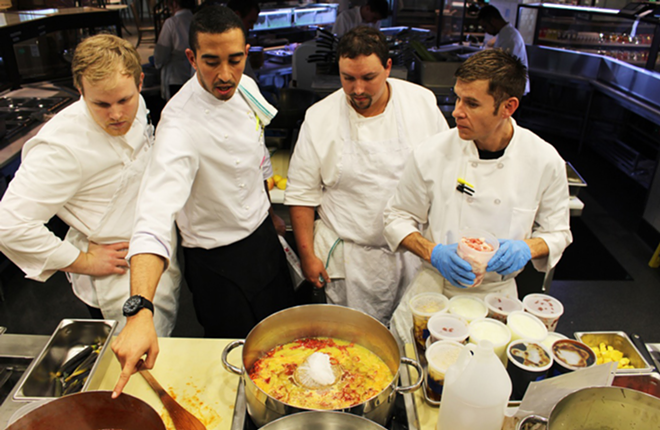 SEAFOOD-FARERS: Sous chef Jalal Bellekat, second from left, teaches From the Sea kitchen staffers how to craft a sauce. - Locale Market