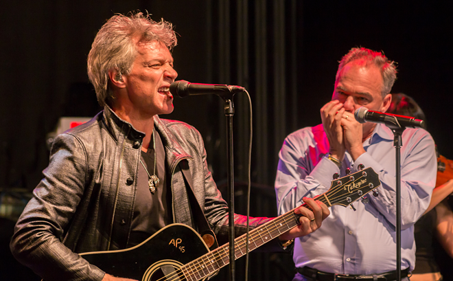 Jon Bon Jovi (L) and vice presidential hopeful Tim Kaine jam at State Theatre in St. Petersburg, Florida on November 5, 2016. - Caesar Carbajal