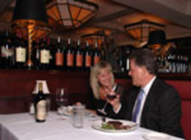 SUIT UP: Cindy Argento and Dave Mann enjoy dinner at Capital Grille, which brings traditional steakhouse ambience to International Plaza. - Lisa Mauriello