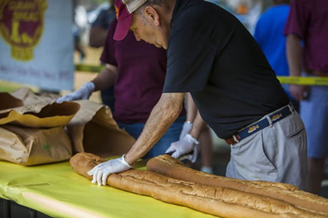 Tony More of La Segunda Bakery prepares bread for the longest Cuban. The bakery is celebrating its 100-year anniversary - Kimberly DeFalco